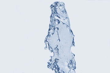 drops of water fountain closeup on a light background