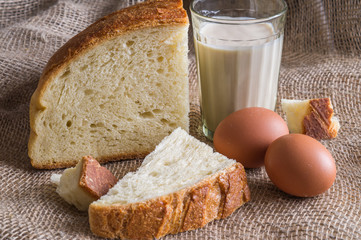 still life with white bread, eggs and salt on the matting