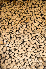 wall firewood , Background of dry chopped firewood logs in a pil