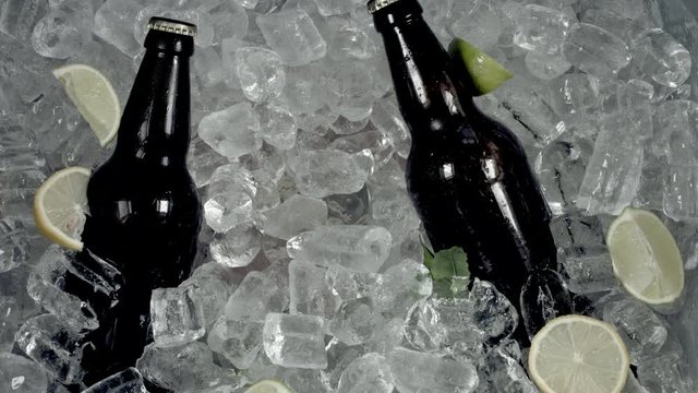 4k Shot of Cold Ice Cubes and Hand Taking Beer Glass