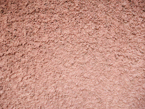 Rough pinkish brown plaster texture
