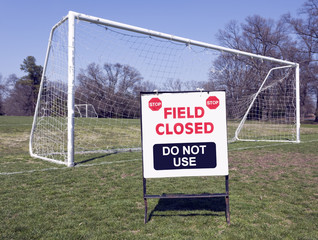 Fototapeta premium FIELD CLOSED SIGN with soccer goal in background. Horizontal.