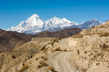 Mountain peak behind a winding road.