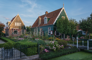 Fototapeta na wymiar Small house with a slate roof and a flowered garden.