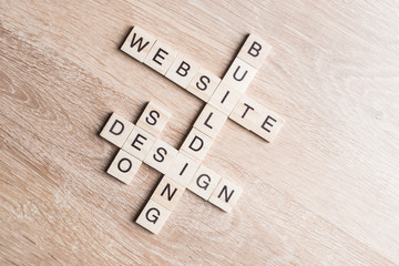 Conceptual media keywords on table with elements of game making crossword