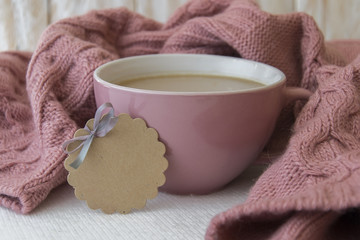 Cup of coffe and warm pink sweater