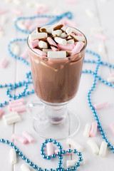 Homemade hot chocolate with colorful marshmallows and syrup.