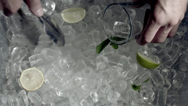 4k Shot of Cold Ice and Hand Grabbing Ice Cubes