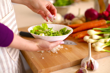 Young Woman Cooking in the kitchen. Healthy Food