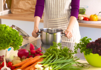 Young Woman Cooking in the kitchen. Healthy Food