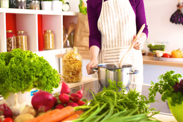 Young Woman Cooking in the kitchen. Healthy Food