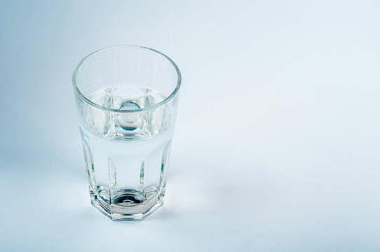 Glass of water on a light background
