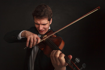 Man playing violin showing emotions and expressions