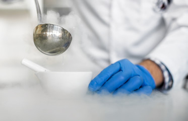 Laboratory technician performs an experiment with liquid nitroge