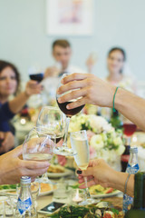 Hands holding glasses and toasting, happy festive moment, luxury