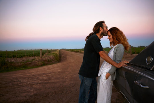 Happy couple enjoying a moment, man kisses woman on forehead