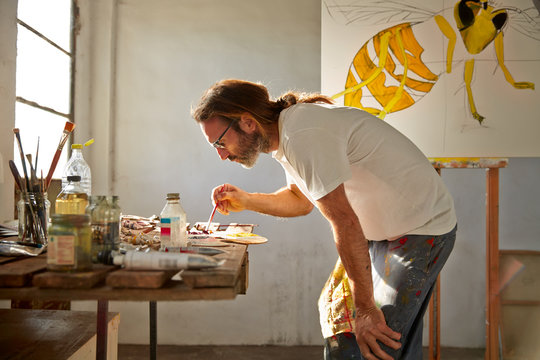 Artist painting in studio