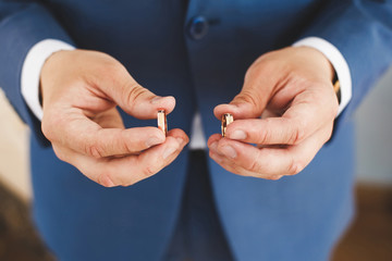 Two wedding rings in a hand of the groom