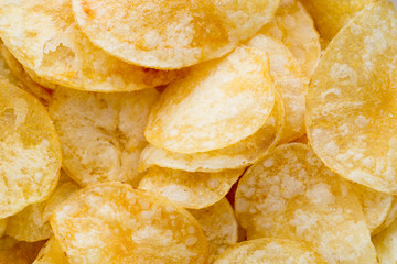 Close up potato chips on wood top view background.
