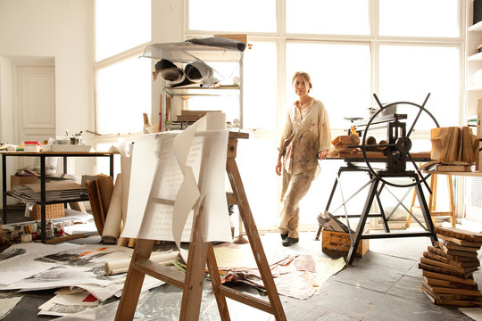 Portrait of a female artist in her light filled studio