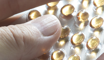 Man takes vitamin D tablet