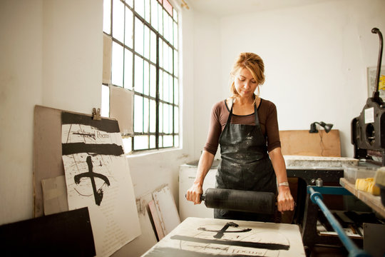 Female Artist At Work In Her Studio