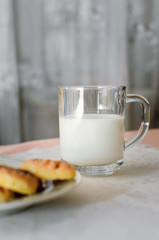 cookies and milk are on a white tablecloth
