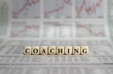 Coaching word on a business newspaper