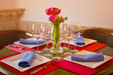 Sweet color Empty glasses and flowers in restaurant  blurred style for the soft background.