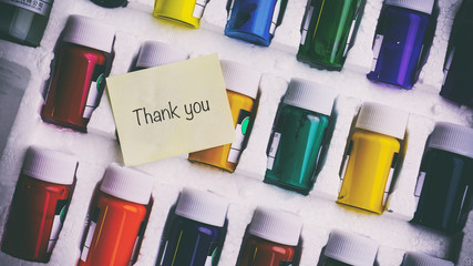 A lot of colorful cans with red, a word on a paper sticker