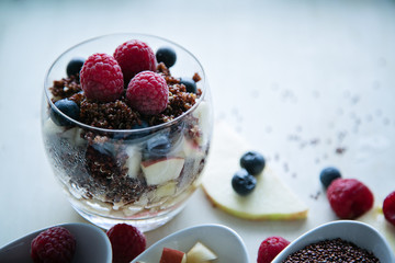 cooked red quinoa with berries and apple breakfast in a glass, l