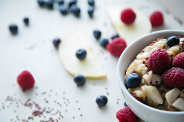 cooked red quinoa with berries and apple breakfast in a bowl, li