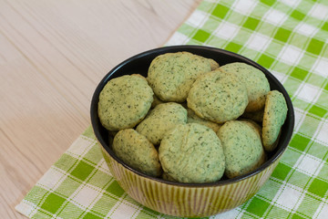 Mint cookies in bowl on green checkered napkin. 