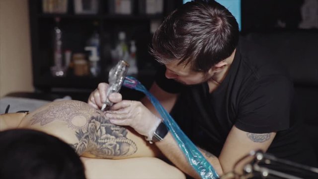 Tattoo artist make tattoo at the studio HD