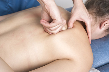 Physiotherapist, chiropractor giving a massage and stretching of