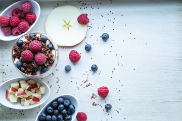 cooked red quinoa with berries and apple breakfast in a glass, l
