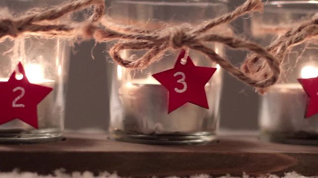 Four Advent candles in the snow, fourth Advent, close up