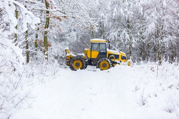 Winter landscape with machine (snow plow at work)