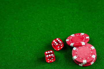 poker chips and dice on green background top view