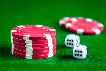 stack of chips play poker on green background close up