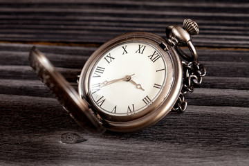 deadline concept pocket watch on wooden background