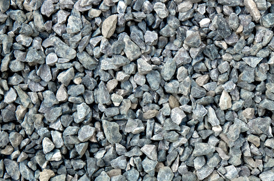 aggregate - a stack of gravel / grit of glauconite sandstone, dark and light gray coarse stones, crushed and broken at a stone pit to similar sizes. The colors and shapes are very irregular.