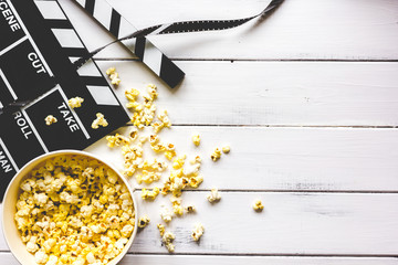 watching movie with popcorn on wooden background top view