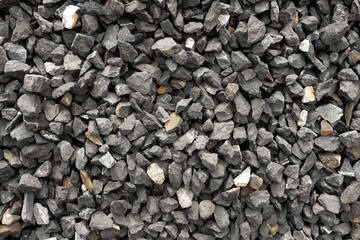 coarse aggregate - a stack of gravel / grit crushed and broken at a stone pit. The colors, sizes and shapes are very irregular.