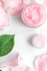 organic cream with rose oil on white background top view