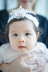 Sweet Beautiful baby girl with hug of mom , Joyful, Happy, Excited. Closeup Headshot