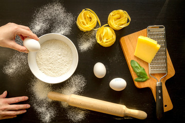 chef cooking pasta top view on dark background