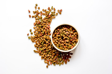 dry cat food in bowl on white background top view