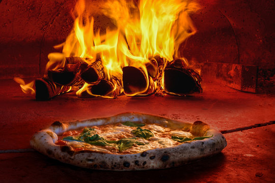 Italian pizza making dough stretching olive oil mozzarella cheese wood fire oven
