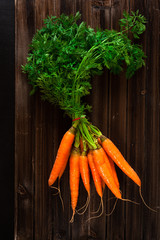 Bunch of Carrots on an old, wooden table